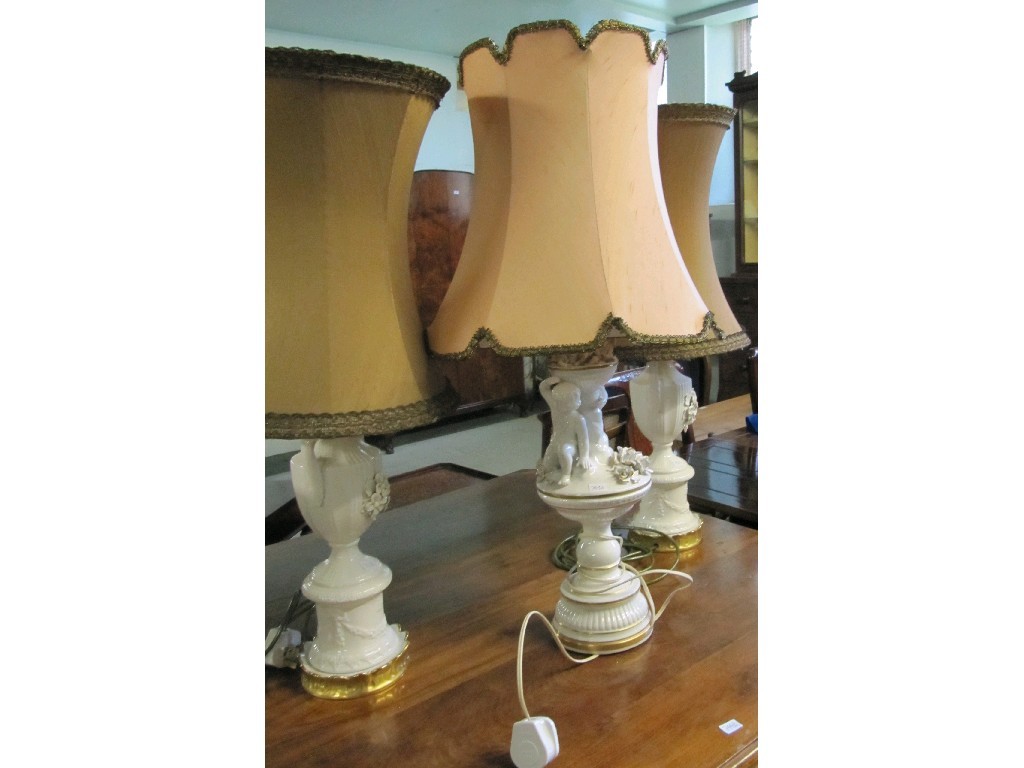 Appraisal: Lot comprising pair of porcelain table lamps and a figural