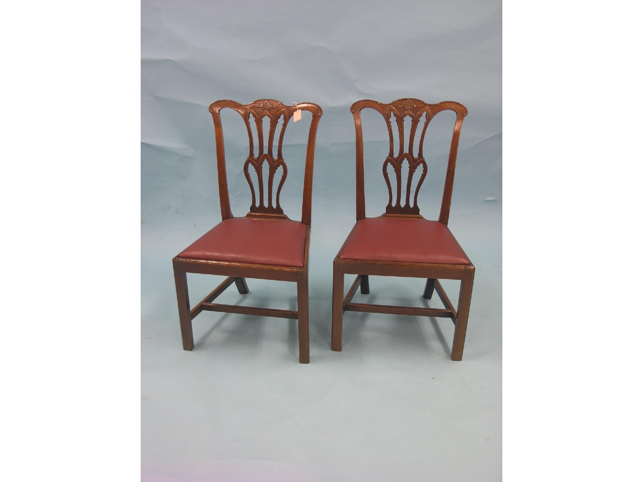 Appraisal: A pair of Chippendale-period mahogany dining chairs with pierced and