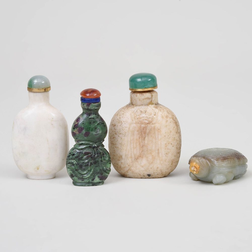 Appraisal: Four Chinese Carved Hardstone Snuff Bottles Comprising A hardstone example