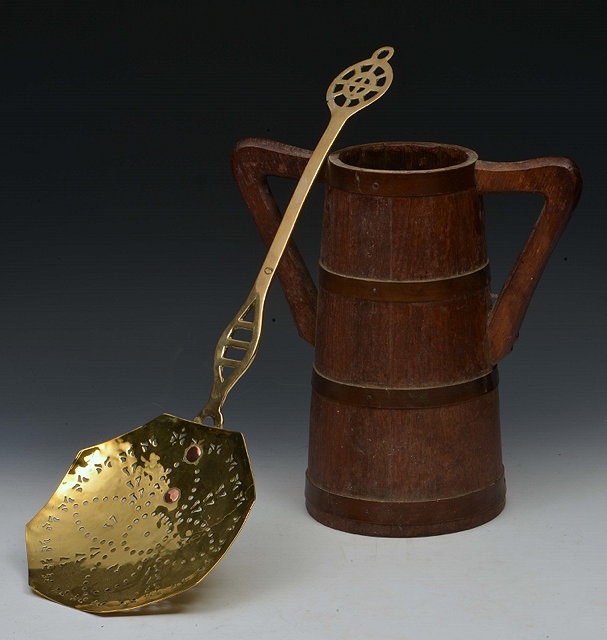 Appraisal: AN ANTIQUE BRASS CREAM SKIMMER with octagonal bowl and pierced