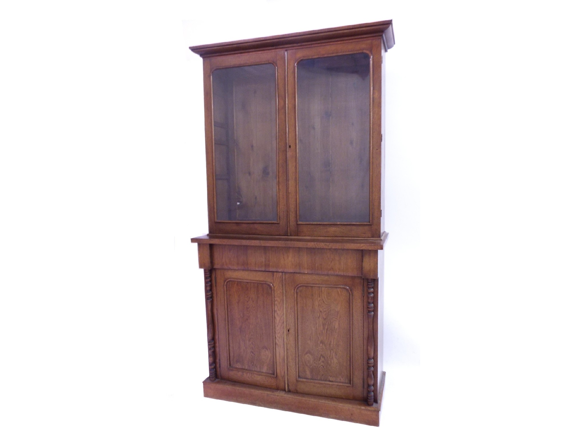 Appraisal: Victorian oak bookcase the raised back with glazed doors enclosing