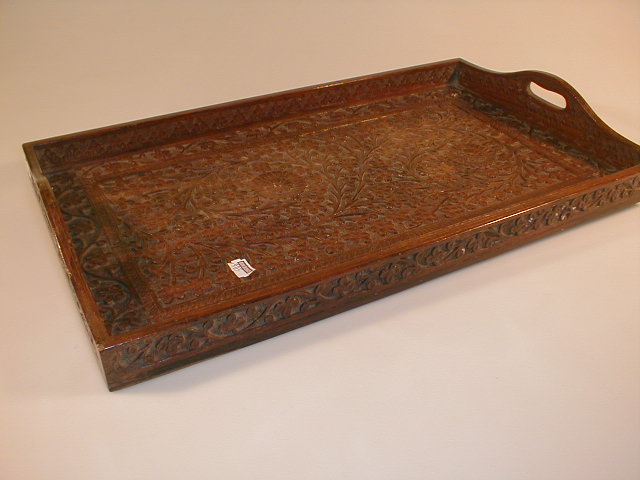 Appraisal: An Indian floral carved teak two-handled tray