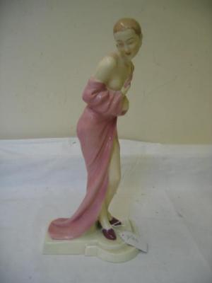 Appraisal: A ROYAL DUX EARTHENWARE FIGURE modelled as a female standing