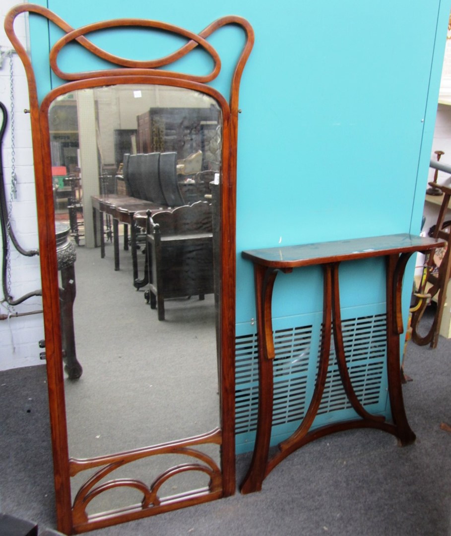 Appraisal: A Thonet bentwood pier mirror and console table shaped plate