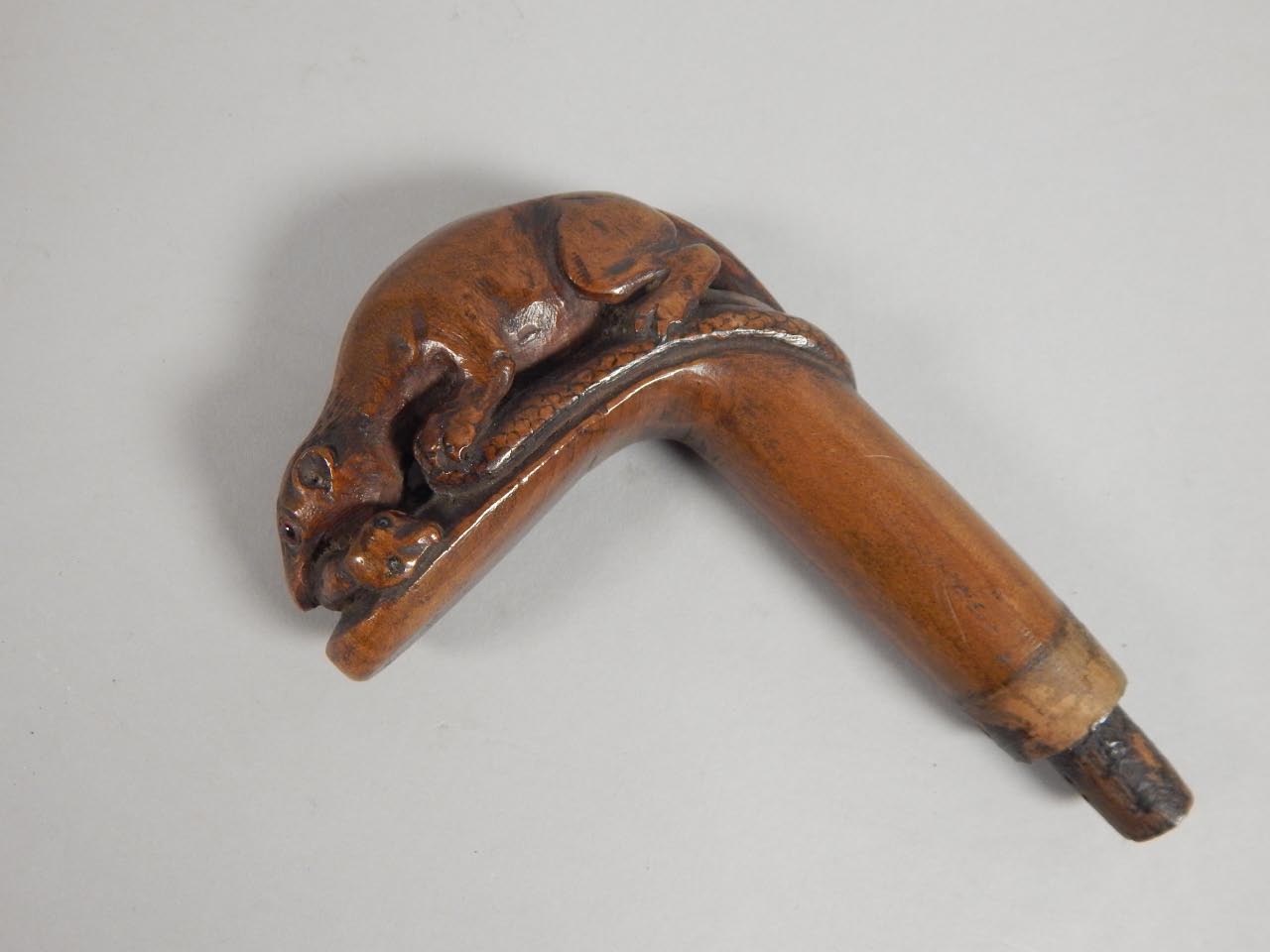 Appraisal: A thC hardwood walking stick handle carved in the form