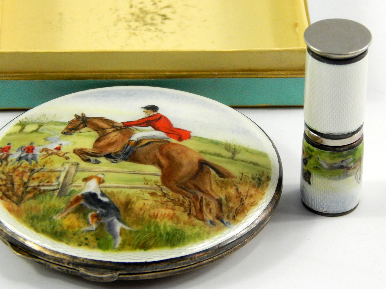 Appraisal: A silver and enamel compact and matching lipstick decorated with