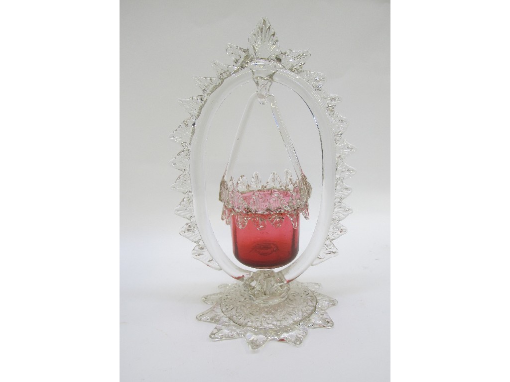 Appraisal: A cranberry glass basket shaped salt hanging on a glass