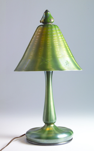 Appraisal: TIFFANY Favrile Damascene glass evergreen-shaped table lamp its conical shade