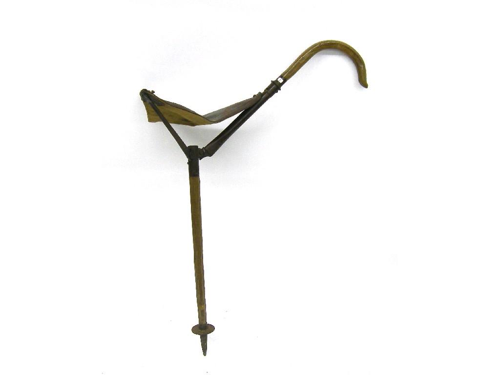 Appraisal: Wooden shooting stick with folding canvas seat