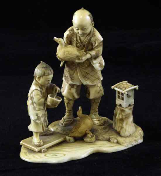 Appraisal: A Japanese ivory group of a man and a boy