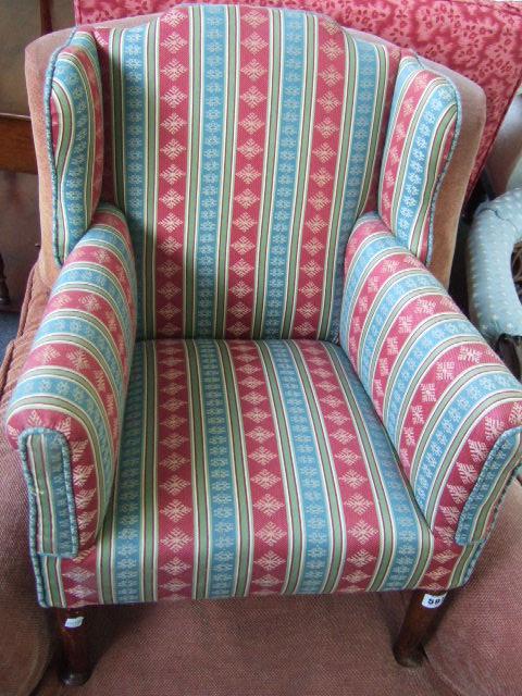 Appraisal: A child's wing armchair upholstered