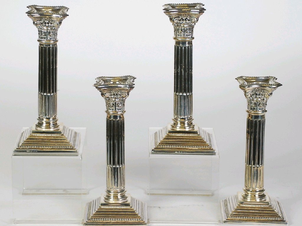 Appraisal: SET OF FOUR MODERN WEIGHTED SILVER CORINTHIAN COLUMN CANDLESTICKS on