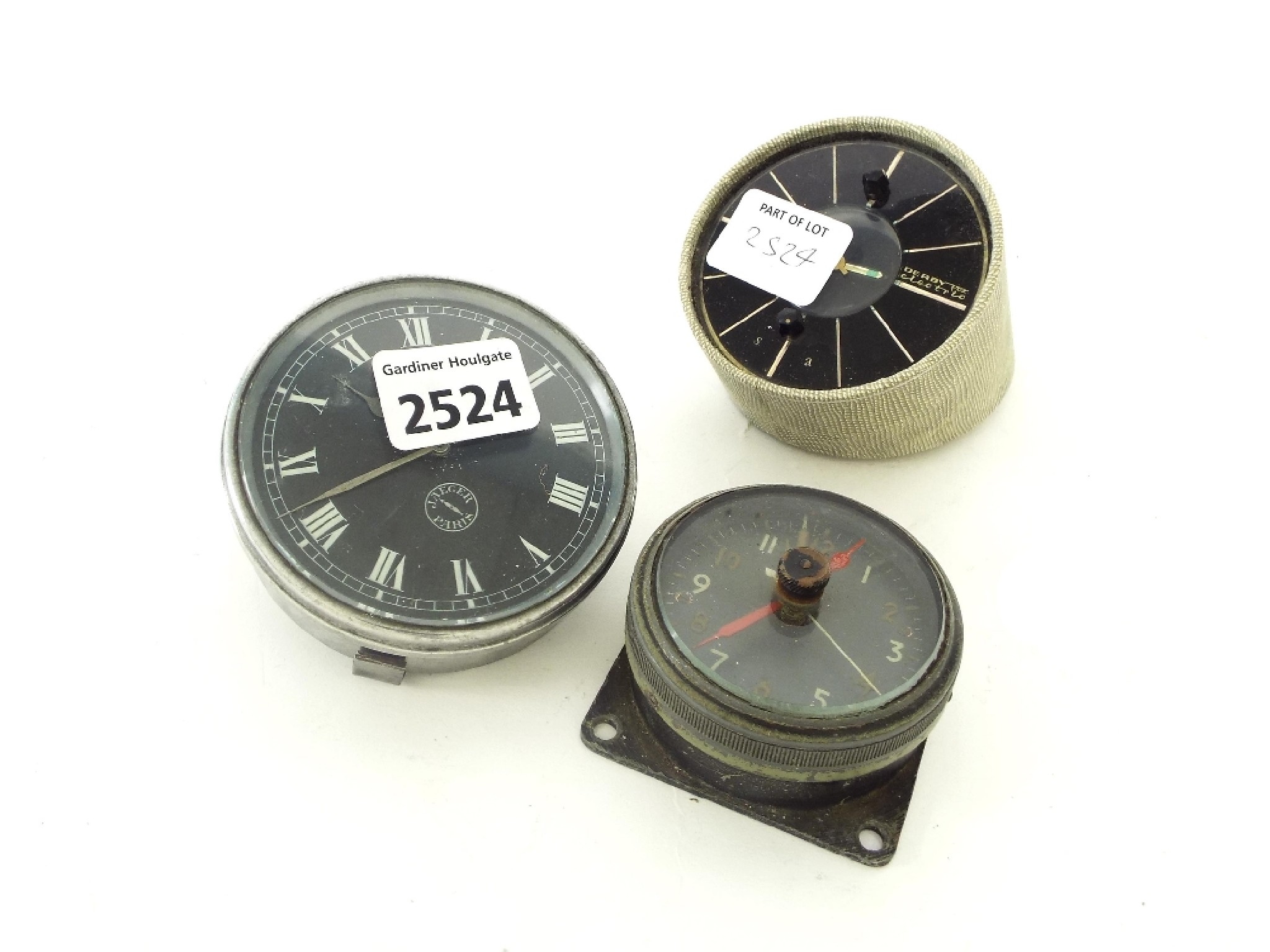 Appraisal: Jaeger car clock together with a blackened metal cockpit clock