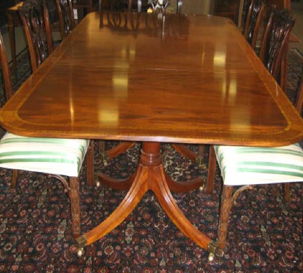 Appraisal: ENGLISH DESIGN TRIPLE PEDESTAL DINING TABLE Cross-banded top resting on