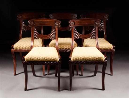 Appraisal: Set of five Regency drapery carved mahogany upholstered klismos chairs