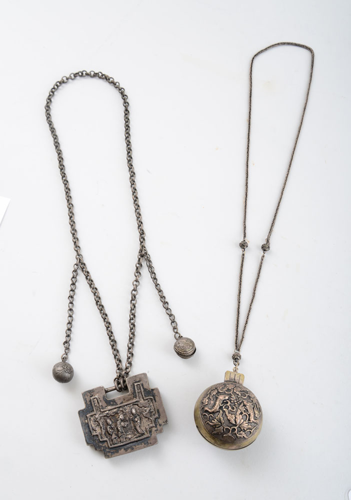 Appraisal: TWO ASIAN SILVERED METAL CHAIN NECKLACES With spherical bell pendant