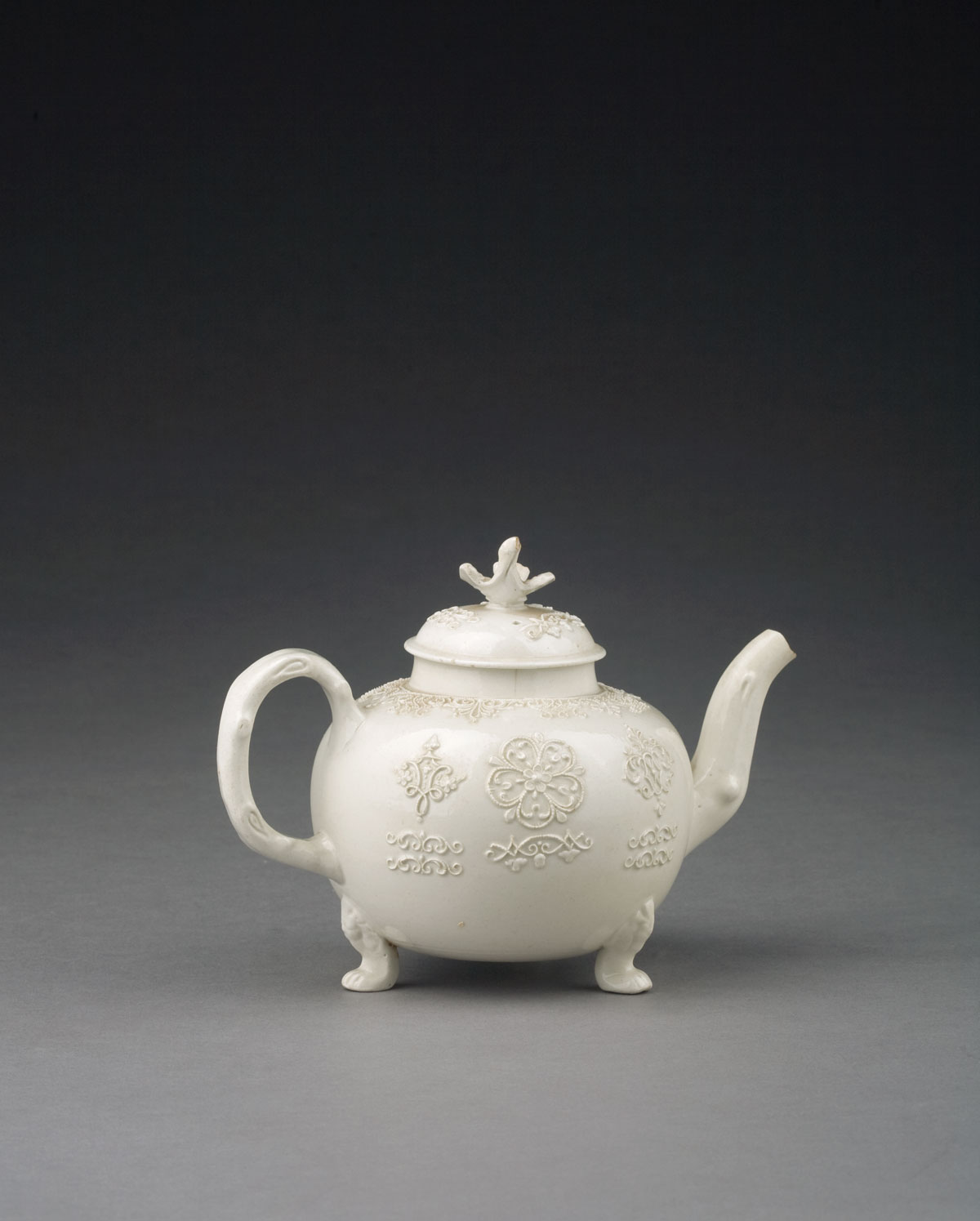 Appraisal: STAFFORDSHIRE SALTGLAZE SPRIGGED TEAPOT AND COVER CIRCA - The spherical