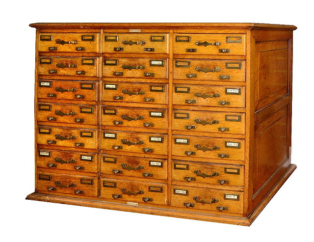 Appraisal: A LIGHT OAK CARD INDEX CABINET fitted drawers with brass