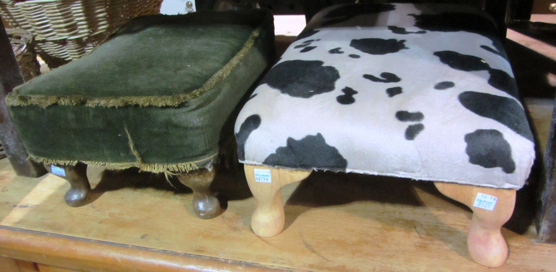 Appraisal: A small green upholstered footstool and another with cow skin