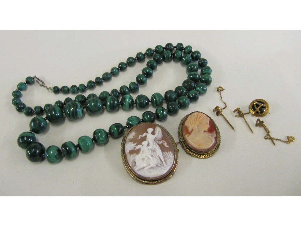 Appraisal: Lot comprising a string of malachite beads two cameo brooches