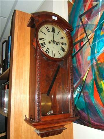 Appraisal: A Continental walnut cased wall clock the circular painted dial