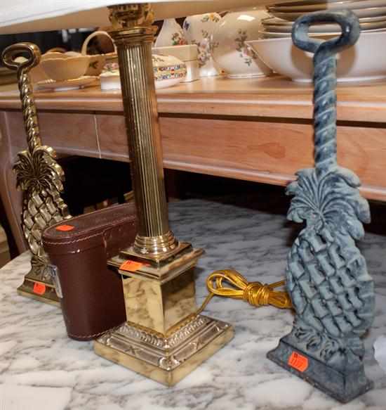 Appraisal: Pair of brass pineapple form doorstops classical style brass candlestick