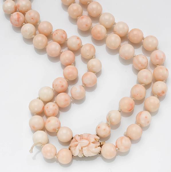 Appraisal: A pink and white coral and k gold double strand