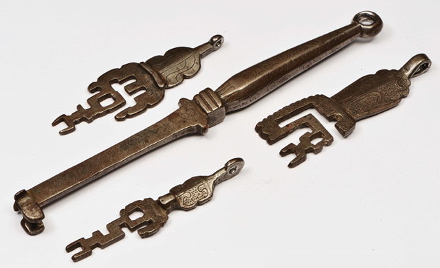 Appraisal: FOUR MIDDLE EASTERN CAST IRON KEYS with engraved scroll decoration