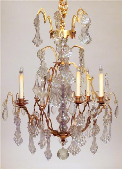 Appraisal: Gilt bronze and luster nine-arm six-light chandelier The central molded