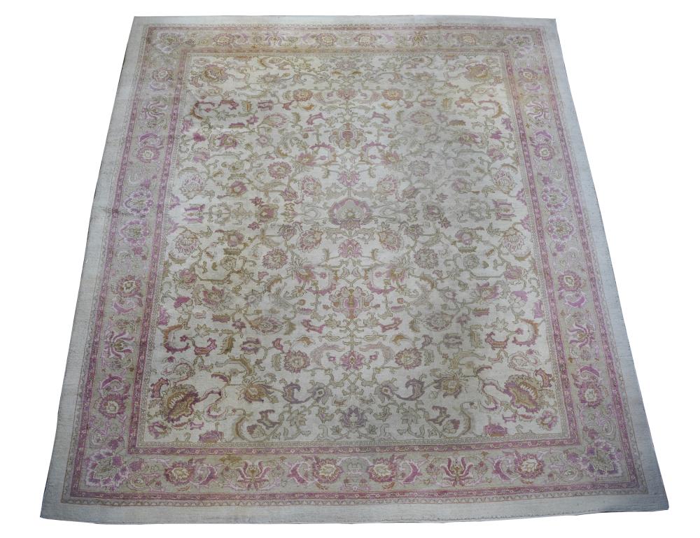 Appraisal: PERSIAN CARPETwool beige field with pink floral motifs ' x