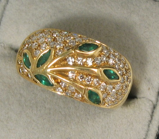 Appraisal: EMERALD DIAMOND AND YELLOW GOLD RING The wide k yellow