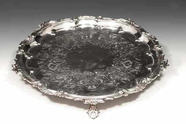 Appraisal: A VICTORIAN SILVER SALVER with scrolled border and matching engraved