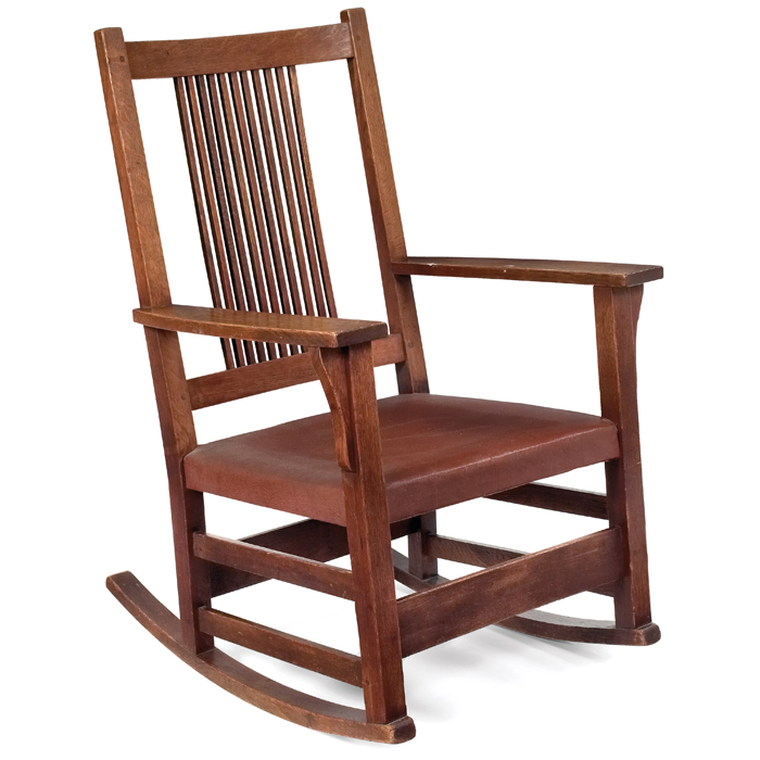 Appraisal: Gustav Stickley rocker A spindle-back form over a recovered leather