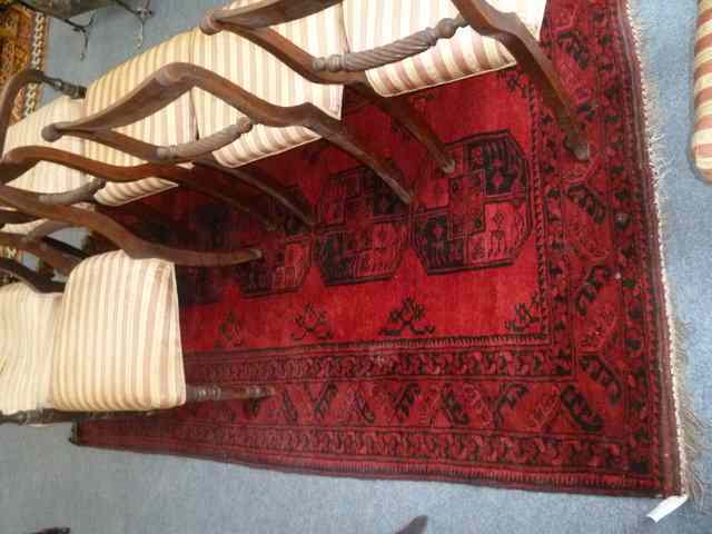 Appraisal: AN AFGHAN MAROON GROUND RUG the centre field with five