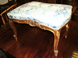 Appraisal: A blue upholstered stool with gilt scrolled supports a mahogany