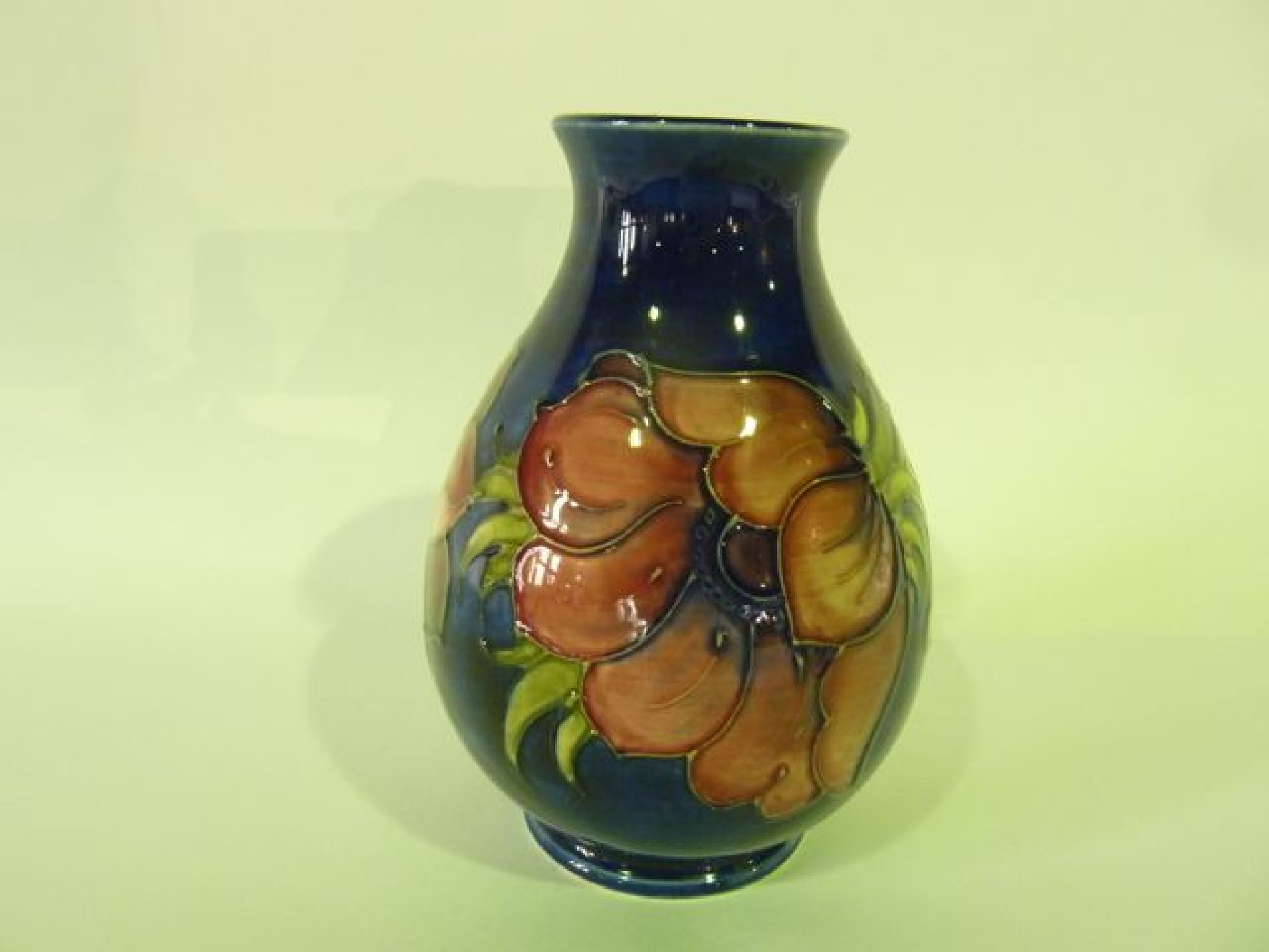 Appraisal: A Moorcroft blue ground vase with anemone decoration in pink