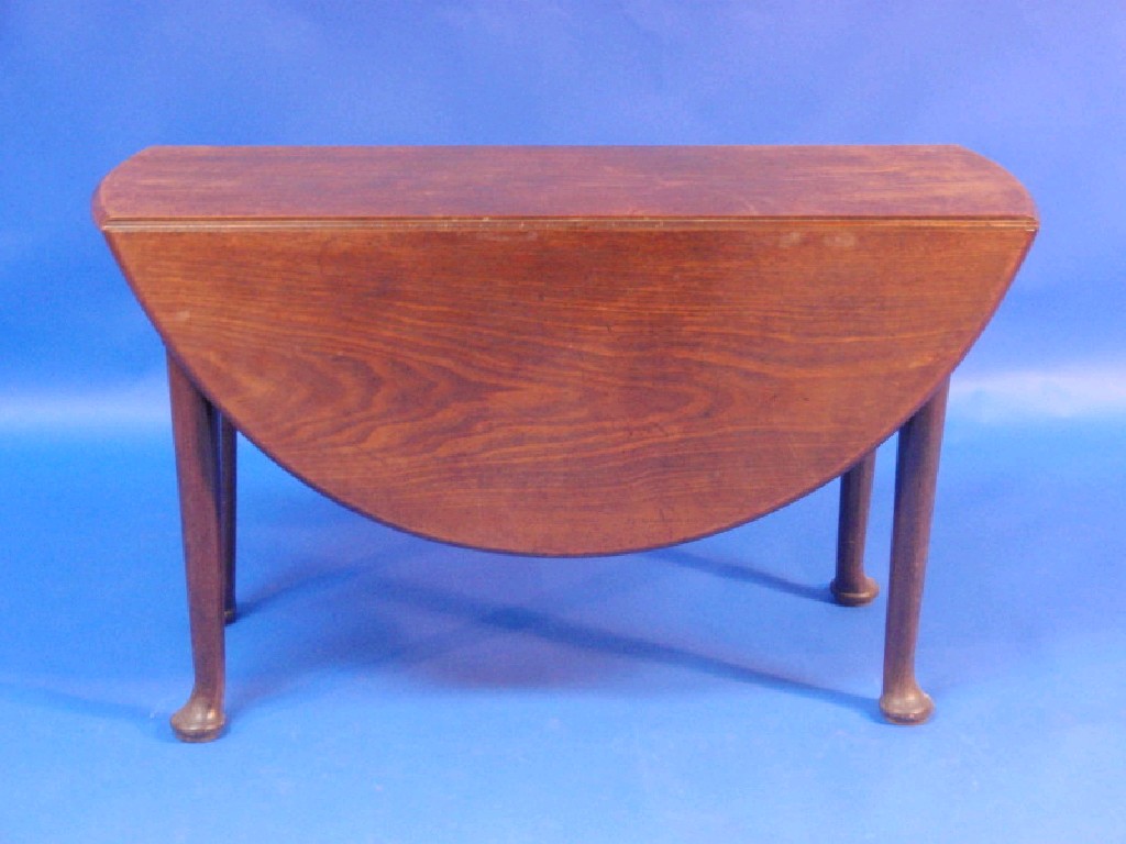 Appraisal: A George II mahogany gateleg table with oval folding top