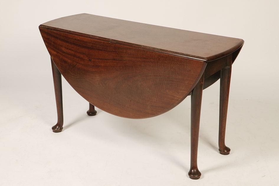 Appraisal: A GEORGE II MAHOGANY PAD FOOT DINING TABLE the shaped