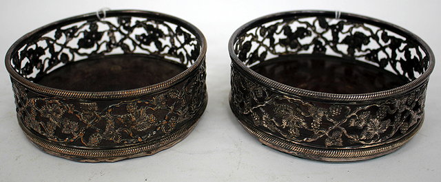 Appraisal: A PAIR OF TH CENTURY SILVER PLATED WINE BOTTLE COASTERS