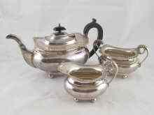 Appraisal: A three piece silver teaset of barge shape on ball