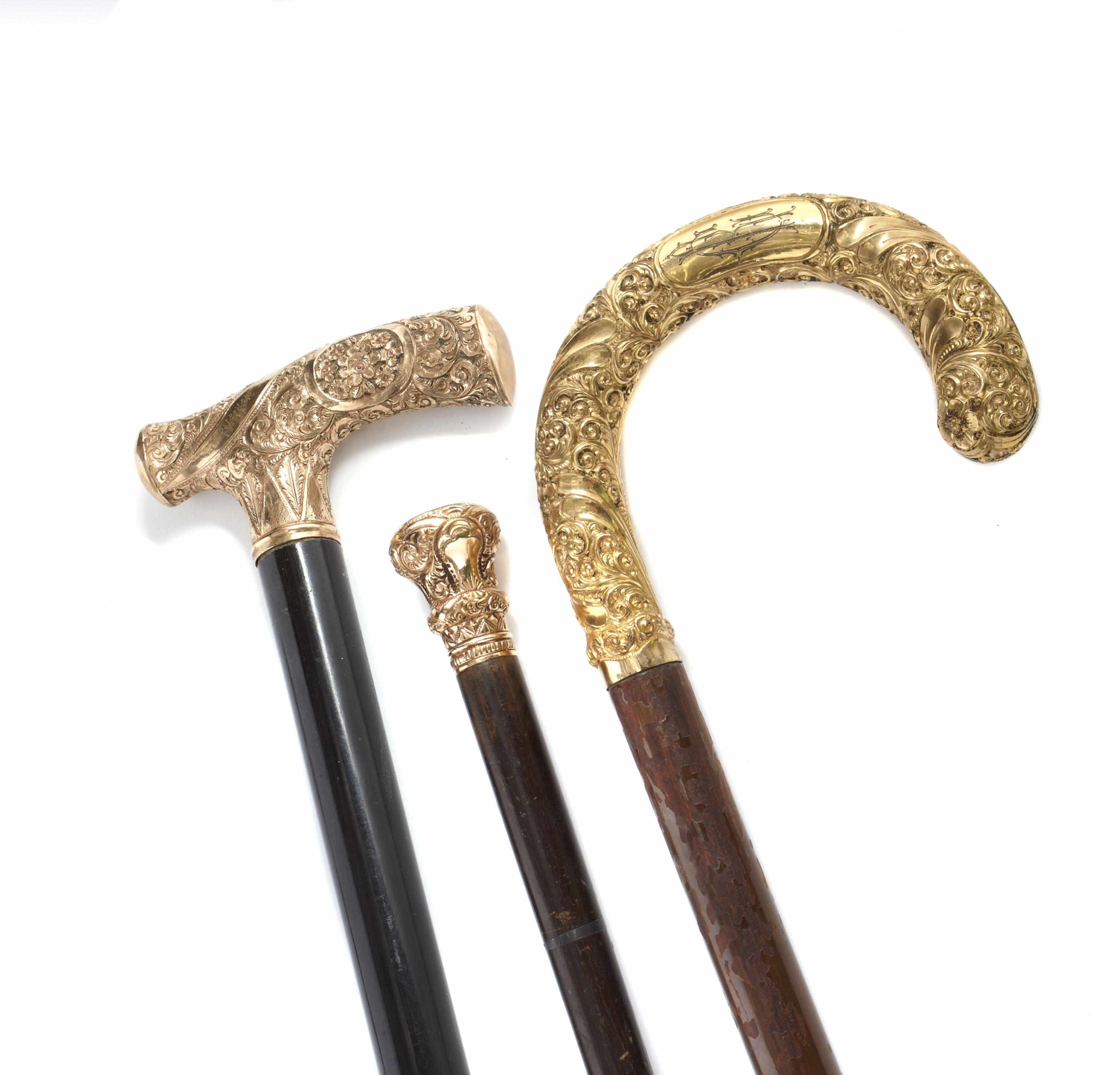 Appraisal: A group of three yellow gold-handled dress canes Late th