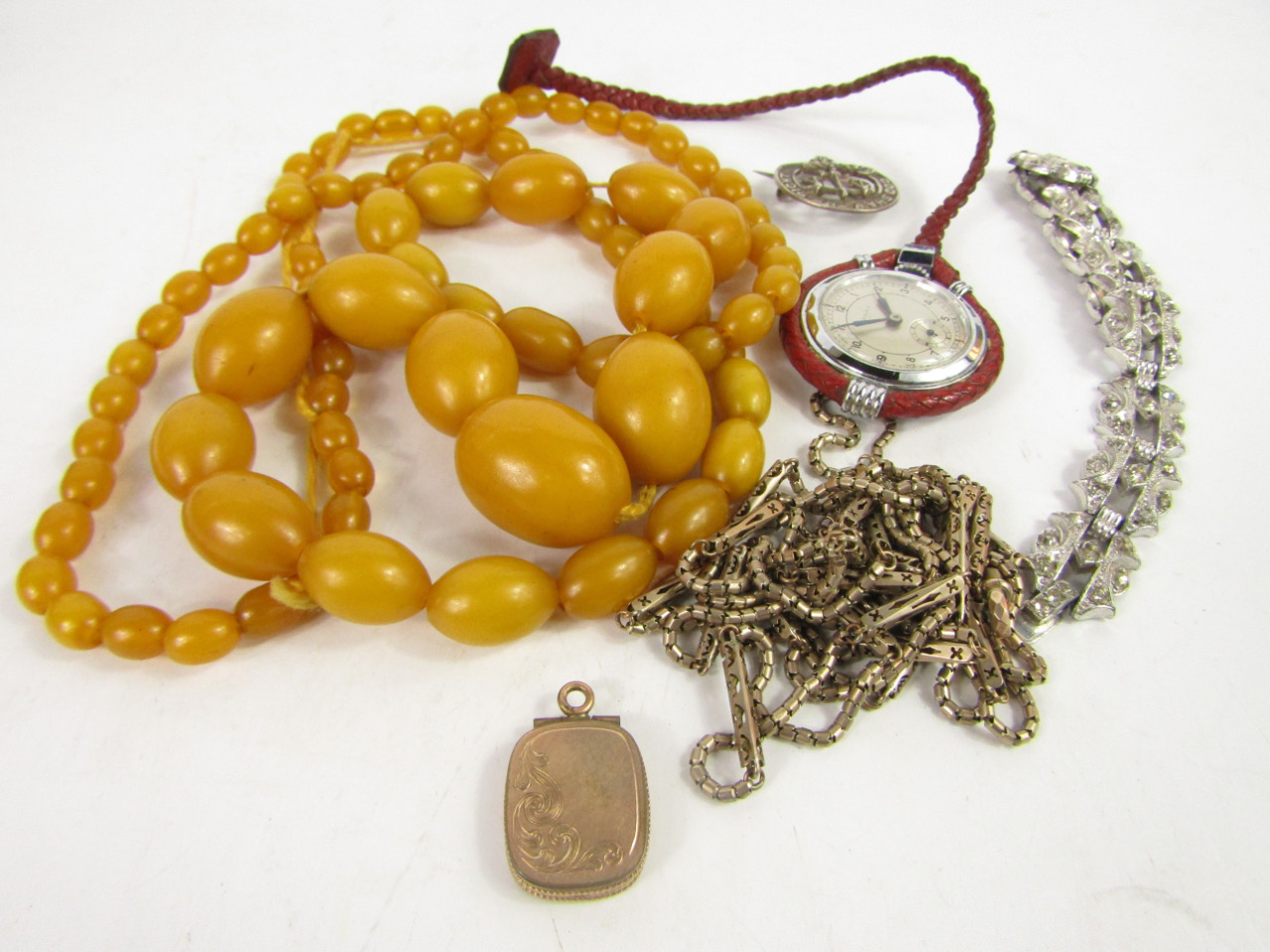 Appraisal: A string of amber style beads g Herma nurse's watch