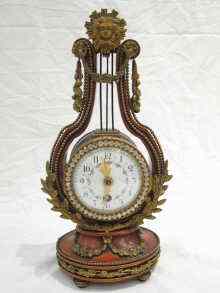 Appraisal: A late th century French ''LYRE'' clock the fruit wood