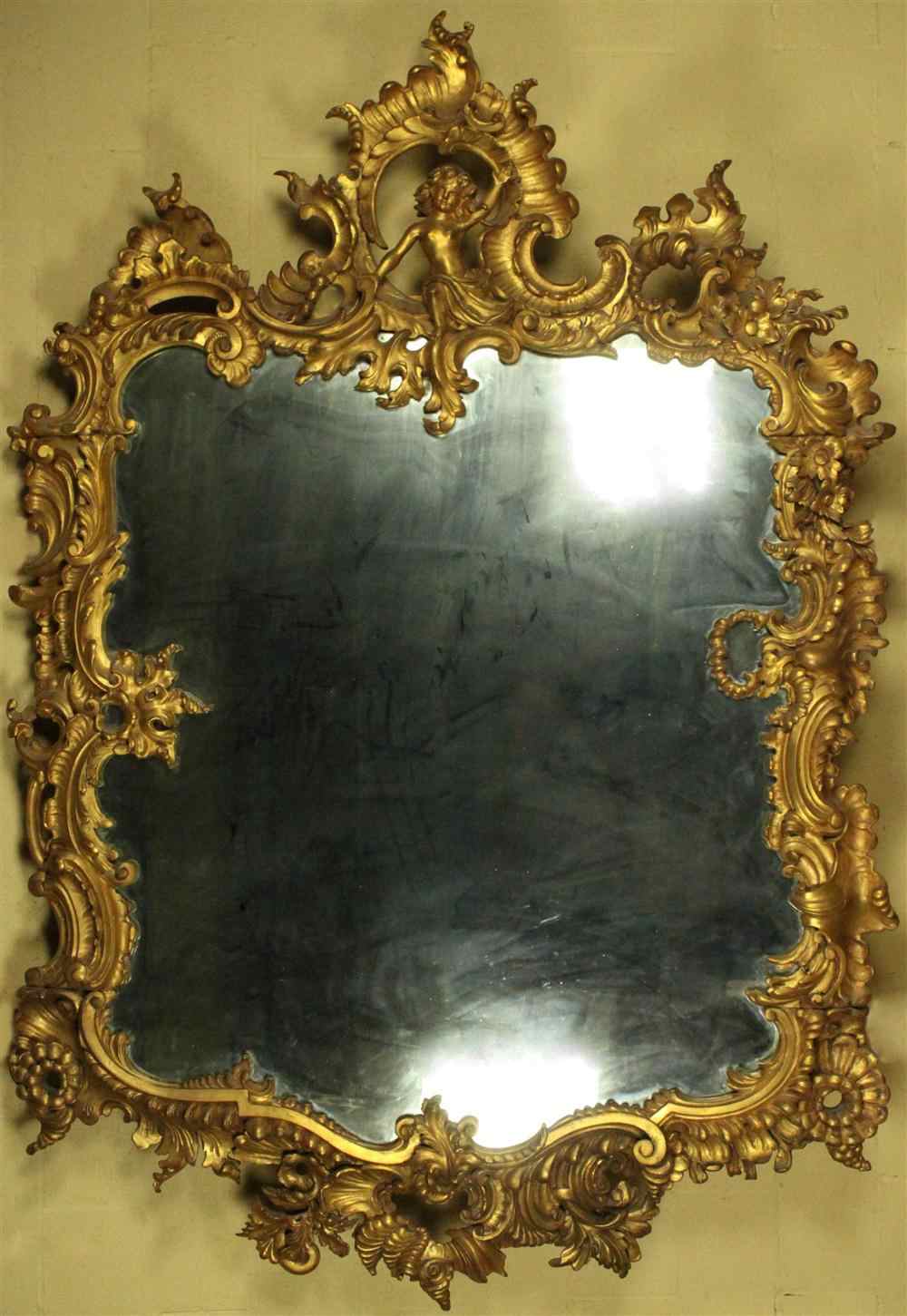 Appraisal: MONUMENTAL ROCOCO STYLE GILDED MIRROR having a large giltwood frame