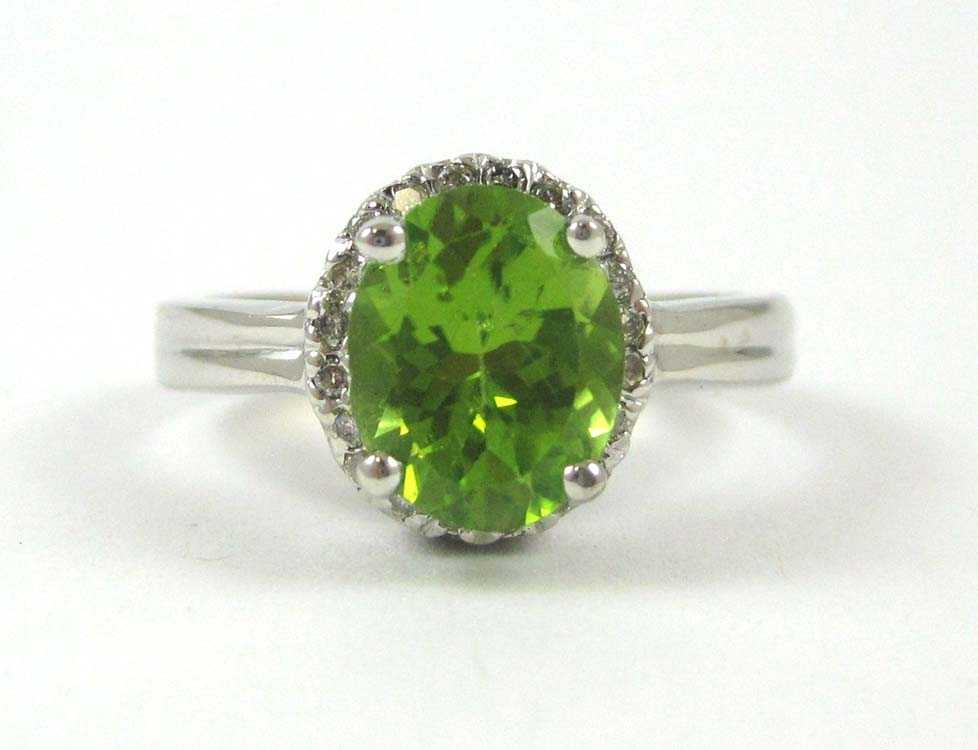 Appraisal: PERIDOT DIAMOND AND FOURTEEN KARAT GOLD RING The white gold