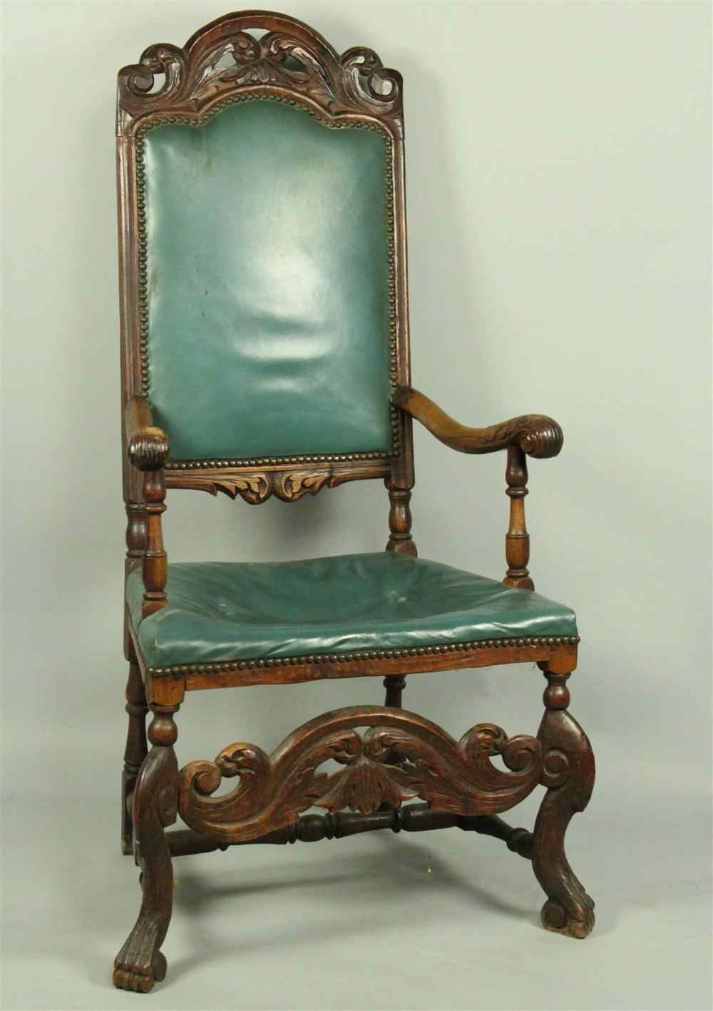 Appraisal: BAROQUE STYLE OAK ARM CHAIR WITH GREEN LEATHER UPHOLSTERY having