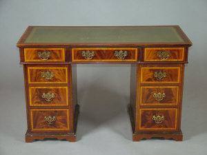 Appraisal: An Edwardian mahogany and satinwood crossbanded twin pedestal desk with