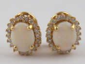 Appraisal: A pair of carat gold opal and diamond earrings opals