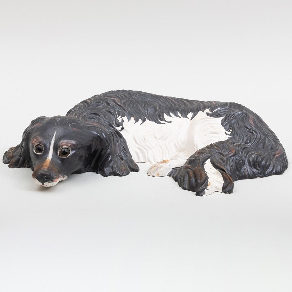 Appraisal: Italian Painted Ceramic Model of a Recumbant Spaniel Black printed