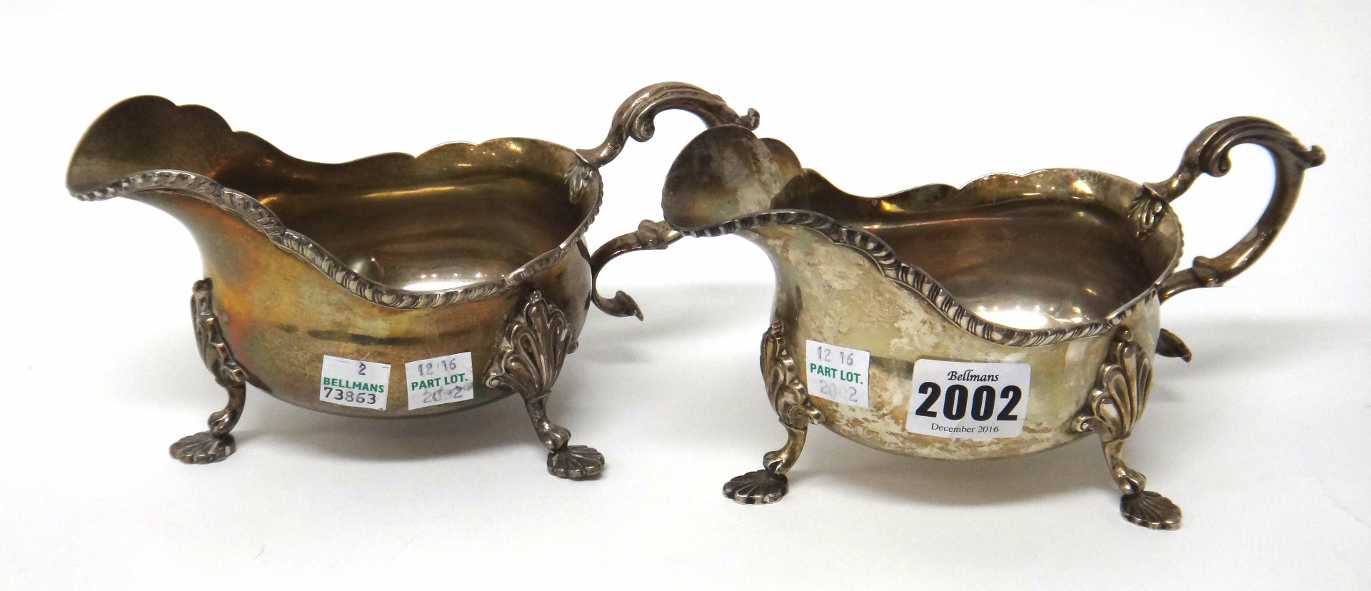 Appraisal: A pair of silver sauceboats each decorated with a shaped